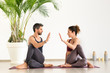 Man and woman duo doing yoga stretching exercises