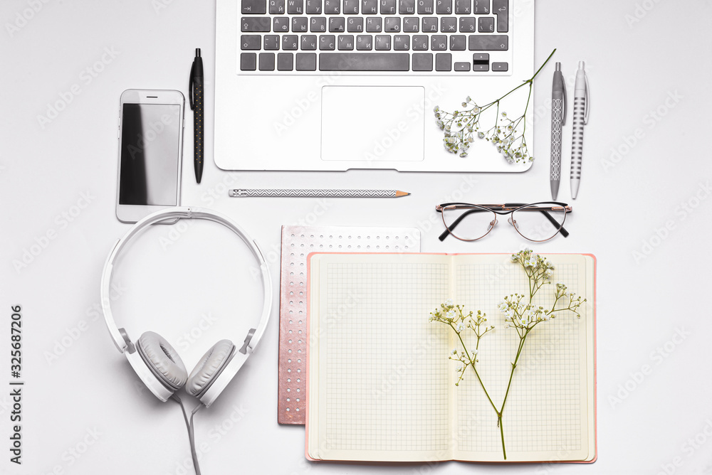 Set of school supplies with modern devices on white background