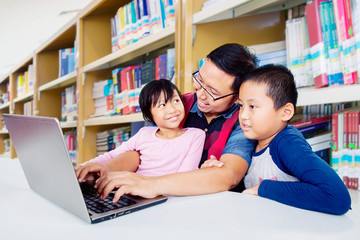 Wall Mural - Father looking at his daughter proudly in library