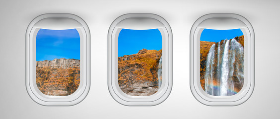 Wall Mural - Airplane windows with Iceland waterfalls view. Travel and holiday abstract concept