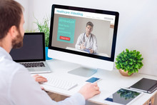 Businessman Consulting Healthcare Website About Coronavirus Disease. Doctor Gives Useful Information About Coronavirus (COVID-19). All Screen Graphics Are Made Up.
