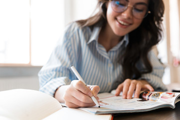 Sticker - Attractive young brunette woman studying in the cafe indoors