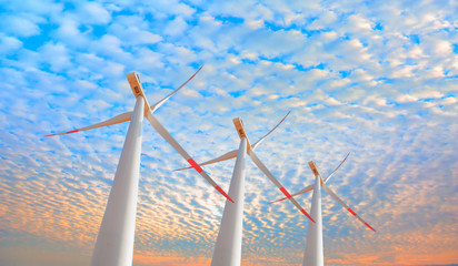 Wind turbines generating electricity with bright blue sky