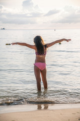 Poster - Young girl embracing ocean. Holiday and relax concept