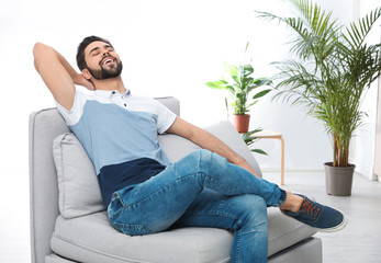 Poster - Young man relaxing on couch at home