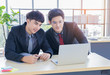 © NONTANUN - Two young business men sit and work on laptops