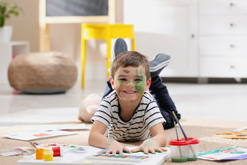 Poster - Little child painting on floor at home