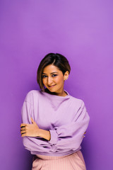 Wall Mural - Amazing young woman portraits in studio - Isolated over colorful bold purple background