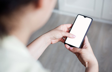 Mockup image of hand holding mobile phone with blank white screen