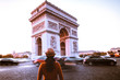 © PORNCHAI SODA - Arc de Triomphe and traveler in Paris street at night twilight
