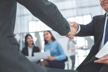 close up. business partners are shaking hands with each other