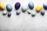 Fototapeta Desenie - Naturally dyed colorful Easter eggs on grey concrete background	