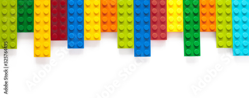Colored toy bricks on white background