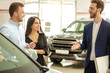 © Roman - young caucasian couple choosing new car in showroom. service, selling. buying and renting cars in dealership. automobile, car, auto, transport