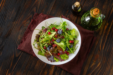 Wall Mural - Bowl of fresh lettuce with berries