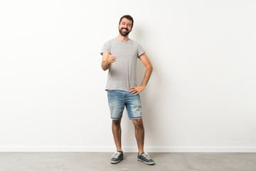 Wall Mural - A full-length shot of handsome man with beard shaking hands for closing a good deal