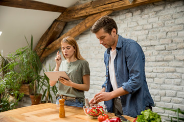 Poster - Couple cooking in the modern kitchen