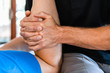 © Valmedia - Close-up view of masseur hands massaging legs of male sportsman. Massage therapist working with pressure on the legs. Therapeutic body massage