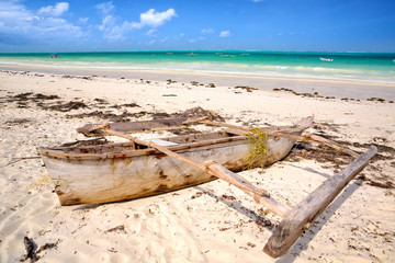 Wall Mural - Tropical white beach with traditional dhow boat in Zanzibar