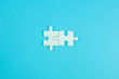© Jo Panuwat D - Jigsaw puzzle pieces on blue background with copy space for text. solutions, mission, successful, goals, cooperation, partnership and strategy concept