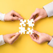 © REDPIXEL - People holds in hand a jigsaw puzzle. Business solutions, success and strategy.