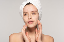 Attractive Girl With Towel On Head Applying Coconut Scrub On Face, Isolated On Grey