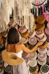 Wall Mural - Woman choosing wicker gifts abroad stock photo