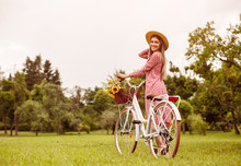 Optimistic Woman With Vintage Bicycle On Lawn