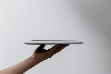 tablet computer isolated in a hand on the white backgrounds.