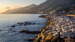 Camogli, Genoa, Italy. Panoramic sunset view on the coast. Landscape illuminated by the warm lights of the sunset