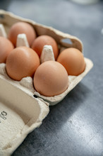 Close-up View Of Raw Chicken Eggs In Egg Box