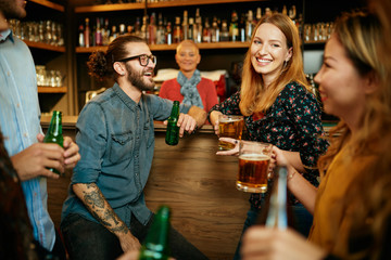 Poster - Group of friends drinking beer, chatting and having good time at pub. Night out.