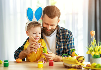 Happy easter! family father and child with ears hare getting ready for holiday.