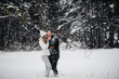 © Andrii - Couple playing with snow in the forest