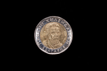 Bulgarian 2 leva coin from 2015, obverse showing stylized image of Paisius of Hilendar with the years 1722-1773. Isolated on black background