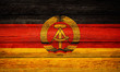 East germany flag wooden plank background