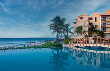 Canvas Print - Swimming pool on a tropical beach at dawn