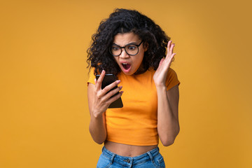 Wall Mural - Portrait of attractive young african american girl using mobile phone