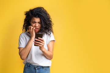 Wall Mural - Portrait of attractive young african american girl using mobile phone