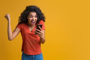 Wall Mural - Portrait of attractive young african american girl using mobile phone