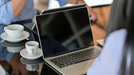 Cropped shot of  businesspeople siting in simple co-working space