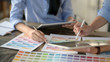© bongkarn - Cropped shot of young designer team consulting on their project