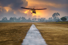 Flying Microlight Aircrafts Flying Pilot Landing On Runway In Rural Country, The Motorized Landing..