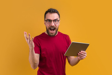 Wall Mural - Young attractive bearded man betting at bookmaker's website