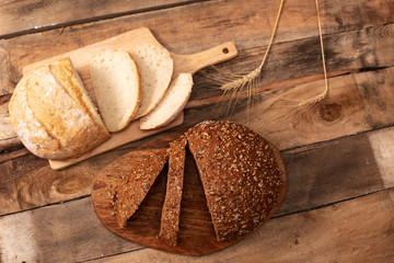 Freshly baked traditional bread on wooden table