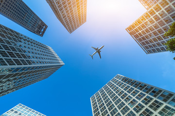 Wall Mural - plane flying over the skyscrapers