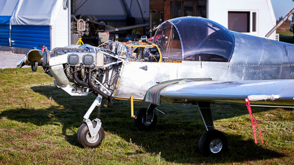 Lightweight single-engine aircraft ready for engine maintenance.