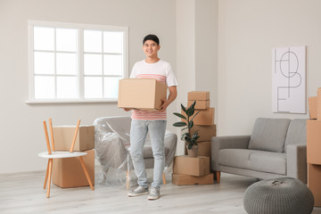 Wall Mural - Asian man with belongings at home on moving day