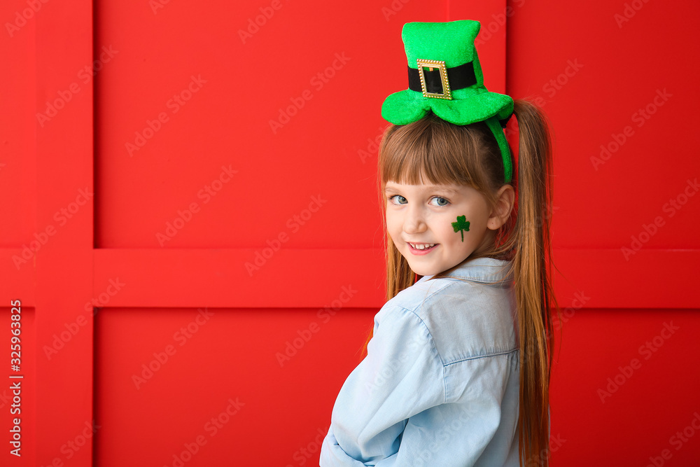Funny little girl on color background. St. Patrick's Day celebration