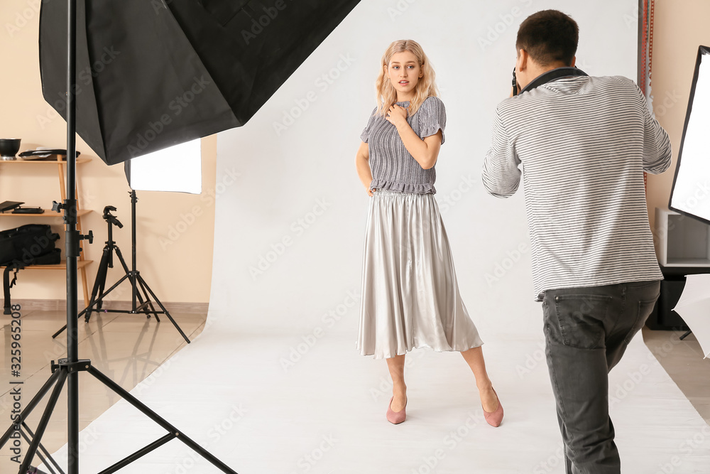 Professional photographer working with model in studio